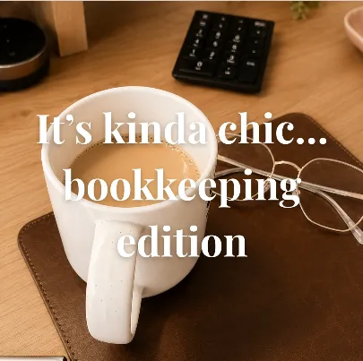 A coffee mug and glasses on a leather desk mat, captioned “It’s kinda chic… bookkeeping edition”.