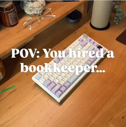 A tidy desk with a keyboard, captioned “POV: you hired a bookkeeper…”.